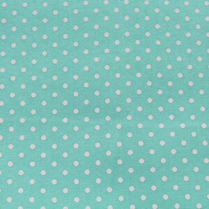 May include: A turquoise fabric with a white polka dot pattern.