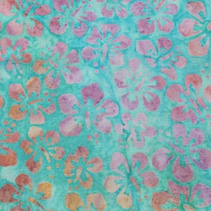 May include: A turquoise fabric with a pink and white floral pattern. The fabric has a batik style design.