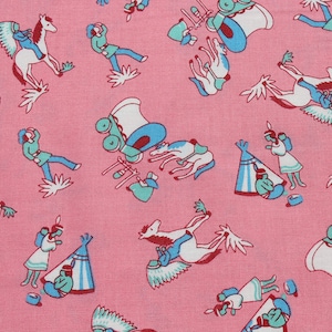 May include: Pink fabric with a repeating pattern of cowboys, horses, and Native American imagery. The pattern includes figures riding horses, a covered wagon, and teepees.
