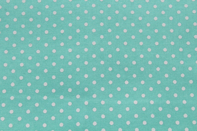 May include: A turquoise fabric with a white polka dot pattern.