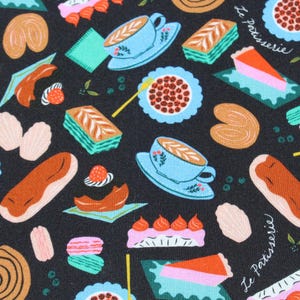 May include: A white ceramic mug with a black handle and the text "But First, Coffee" in a bold, black font. The mug is set against a neutral background, highlighting its simple design.