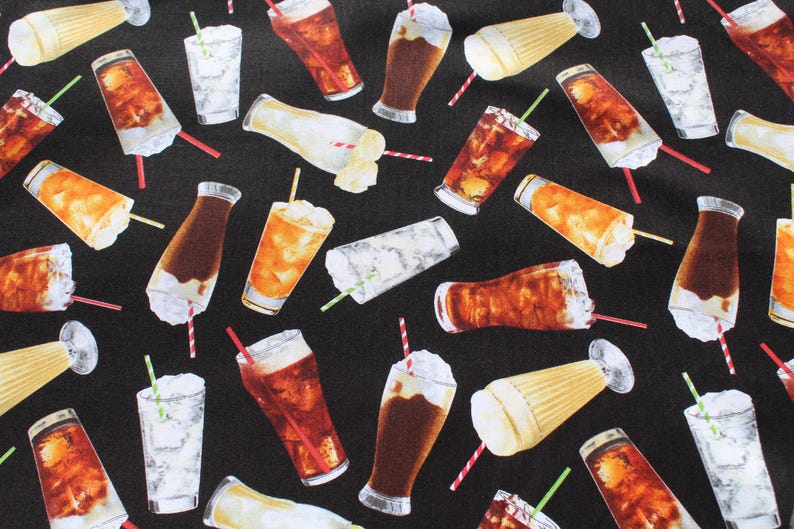 May include: Black fabric featuring a repeating pattern of various drinks, including cola, milkshakes, and iced beverages. The drinks are in different glasses and bottles, with straws and whipped cream. The colours include brown, white, and yellow.
