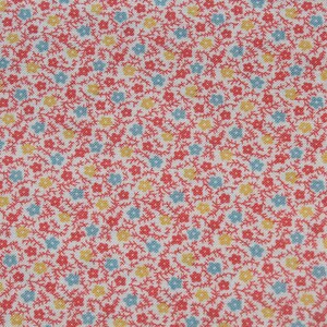 May include: Close-up of a fabric with a repeating floral pattern. The design features small red, yellow, and light blue flowers with green stems on a white background. The fabric has a textured appearance.
