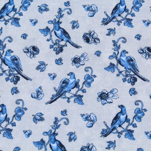 May include: Close-up of a fabric with a repeating pattern of blue birds perched on branches with leaves and flowers. The birds and floral elements are in a detailed, stylized design against a light background.