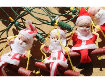 NOMA Christmas Light String, 10 Spun Cotton Felt Santa Claus on Swing, Works