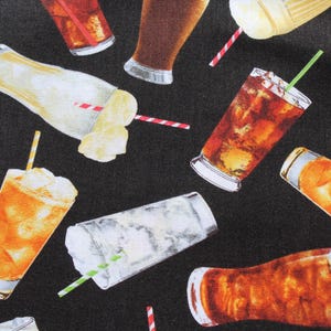 May include: A fabric design featuring a pattern of cold drinks, such as iced tea, fizzy drinks, and milkshakes, with ice and straws. The drinks are in clear glasses and paper cups, set against a black backdrop.