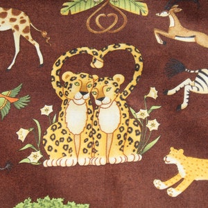 May include: Brown fabric with a repeating pattern of cartoon animals. Two leopards form a heart shape with their arms. Other animals include a giraffe, zebra, gazelle, and elephant. Green foliage and white flowers are also present.