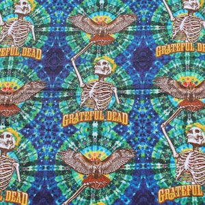 May include: A colorful tie-dye fabric with a repeating pattern of skeletons, hawks, and the words "Grateful Dead".