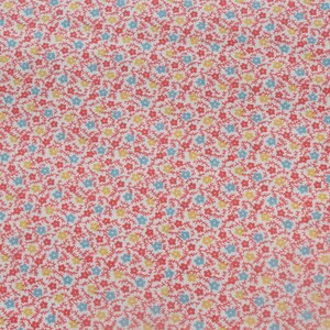 May include: Close-up of a fabric with a repeating floral pattern. The design features small red flowers, light blue and yellow blossoms, and thin red stems against a white background. This fabric is suitable for various sewing and crafting projects.