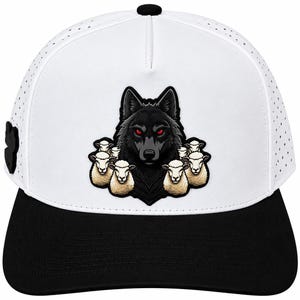 May include: A white baseball cap with a black brim and a perforated crown. The front features a graphic patch of a black wolf with glowing red eyes surrounded by a group of white sheep. A small black emblem is visible on the side of the cap.