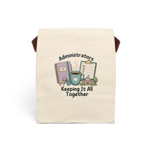 May include: A cream-coloured canvas lunch bag featuring a graphic print of a purple notebook, a clipboard, a teal coffee mug with a heart, keys, and a school building. The text reads Administrators Keeping It All Together in dark lettering.