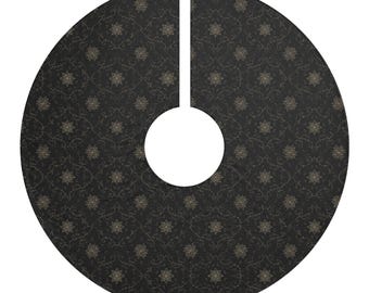 May include: A circular tree skirt featuring a black background with a repeating pattern of gold-toned, intricate floral motifs. The skirt has a central circular cutout and a straight slit extending to the outer edge for placement around a tree.