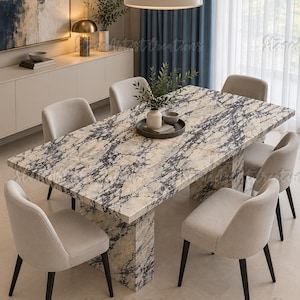 May include: A rectangular dining table with a cream and black marble-patterned surface and a matching pedestal base, surrounded by six upholstered chairs with light beige fabric and dark brown wooden legs, arranged in a dining room setting.