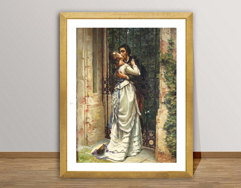 May include: A framed print of a romantic scene. A man and woman embrace and kiss near a wrought iron gate. The woman wears a white dress with blue accents. The artwork is in a gold frame.