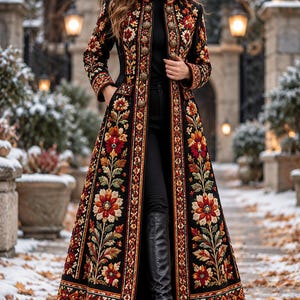 May include: A long black coat featuring intricate floral embroidery in shades of red, orange, yellow, and green. The garment has a high collar, a central row of metallic buttons, and a structured silhouette that extends to the ankles.