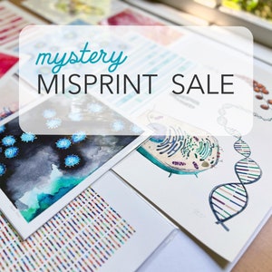 May include: A close-up of a table with several prints on it. The prints are all different and feature various scientific illustrations. The text "mystery MISPRINT SALE" is written in a white box on top of the prints.