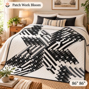 May include: A quilt featuring a black, white, and gray geometric pattern of triangles and stripes on a white background. The quilt measures 86 inches by 86 inches and includes the text Patch Work Bloom in the upper left corner.