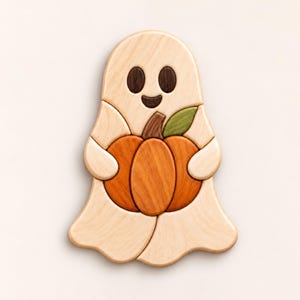 May include: A wooden puzzle shaped like a ghost holding an orange pumpkin. The ghost is light beige with dark brown eyes and a mouth. The pumpkin features a brown stem and a single green leaf. The puzzle is composed of several interlocking pieces.
