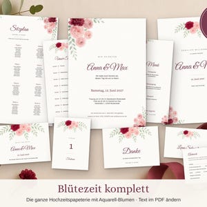 Puede incluir: Un conjunto de papelería de boda en papel blanco con motivos florales en acuarela en tonos burdeos y rosa. El set incluye un plano de asientos, invitación, menú, tarjeta de agradecimiento y tarjeta de respuesta con el texto Anna & Max.