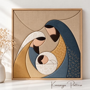 May include: A square wall art piece featuring a fabric-covered nativity scene with stylized figures in shades of blue, gold, and beige. The design uses layered fabric panels with floral and solid textures. The text Kinusaiga Pattern is visible.
