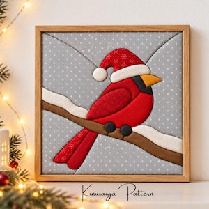 May include: A square framed Kinusaiga pattern art piece featuring a red cardinal bird wearing a white-trimmed red Santa hat. The bird is perched on a brown branch covered in white snow against a light gray background with white polka dots.