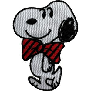 May include: An embroidered patch featuring a white cartoon dog with a black ear, nose, and eyes. The dog is wearing a red and black striped bow tie. The design is outlined in black thread, creating a distinct character shape on a white background.