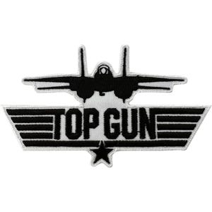 May include: A black and white embroidered patch featuring a silhouette of a fighter jet positioned above the text TOP GUN, which is set against a background of horizontal stripes with a single black star centred below the lettering.