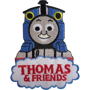May include: An embroidered patch featuring the blue steam locomotive character Thomas with a grey face, black chimney, and yellow-rimmed eyes. Below the train is a white cloud-shaped background with the red text THOMAS & FRIENDS embroidered.