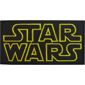 May include: A rectangular embroidered patch featuring the text STAR WARS in bold, yellow, stylised lettering against a solid black background. The embroidery has a visible thread texture throughout the design, creating a clean, defined border.