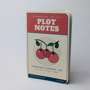 May include: A rectangular garden log notebook titled PLOT NOTES with a red top section and cream-colored cover. The center features a graphic of three red tomatoes on a vine. Text includes VEGETABLE GARDEN LOG, sow grow harvest repeat, and POCKETLEDGER CO. 40 PAGES.