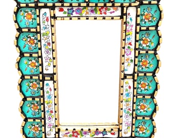 May include: A turquoise and gold picture frame with a decorative floral design. The frame is made of wood and has a scalloped edge.