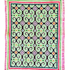 May include: A colorful square-shaped textile with a geometric pattern of green, pink, purple, and black swirls. The textile has a white background and a pink and green border.