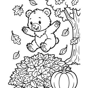 May include: A black and white line art coloring page featuring a cartoon bear jumping into a large pile of fallen autumn leaves. A tree stands to the right, and a pumpkin sits on the ground next to the leaf pile. Several leaves are floating in the air around the bear.