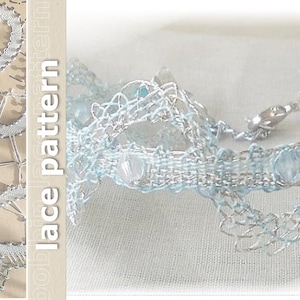 May include: A delicate silver and light blue lace bracelet with a silver clasp. The bracelet is made with a woven pattern and features small, clear beads.
