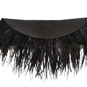 May include: A black feather trim headband with a woven straw band.