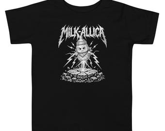May include: A black short-sleeve t-shirt featuring a white graphic print of an angry baby bottle character hovering above cracked ground with lightning bolts. The text MILK-ALLICA is printed in a jagged, metallic-style font above the character.