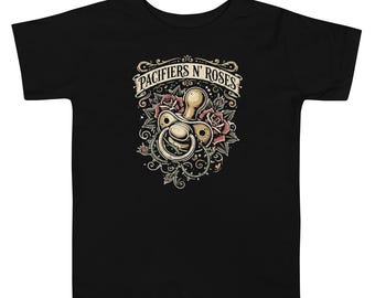 May include: A black short-sleeve t-shirt featuring a graphic print of a baby pacifier surrounded by red roses and green leaves. Above the pacifier, a banner displays the text "PACIFIERS N' ROSES" in a bold, decorative font.