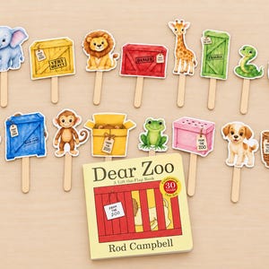 May include: A Dear Zoo lift-the-flap book by Rod Campbell accompanied by a collection of animal and crate-themed paper cutouts on wooden sticks, featuring illustrations of an elephant, lion, giraffe, snake, camel, monkey, frog, and puppy.