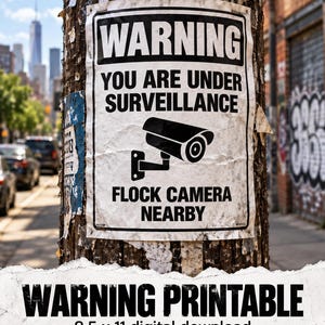 May include: A rectangular white paper sign with black text and a black security camera icon. The sign reads WARNING YOU ARE UNDER SURVEILLANCE FLOCK CAMERA NEARBY. The paper is wrinkled and attached to a wooden utility pole.