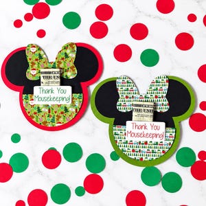 May include: Two mouse-shaped paper cards with black ears and colorful holiday-themed patterns. Each card features a bow, a small pocket holding a dollar bill, and a white label with the printed text Thank You Mousekeeping!
