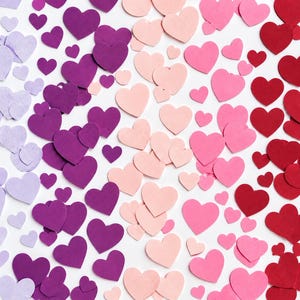 May include: A collection of numerous heart-shaped cutouts arranged in a gradient pattern. The colors transition from light lavender on the left, through deep purple and soft pink, to vibrant red on the right side of the composition.