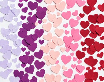 May include: A collection of numerous heart-shaped cutouts arranged in a gradient pattern. The colours transition from light lavender on the left, through deep purple and soft pink, to vibrant red on the right side of the composition.