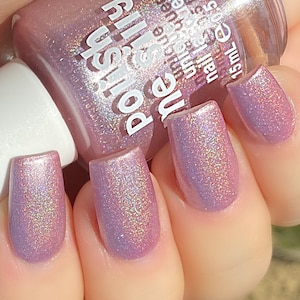May include: A bottle of pink nail polish with a shimmery finish. The bottle is labeled "ne Silly" and "polish". The bottle is 0.5 fl oz or 15 mL.