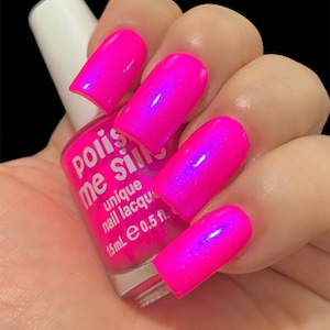 May include: A bottle of pink nail polish with a white label that reads "Poliss me Silly" and "unique nail lacquer 15mL e 0.5 fl."