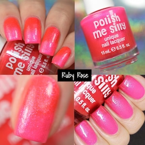 May include: Pink nail polish bottle with the text "Polish me silly" and "unique nail lacquer" on the label. The bottle is 0.5 fl. oz. and contains a pink shimmery nail polish. The image shows a hand with pink nails painted with the polish.