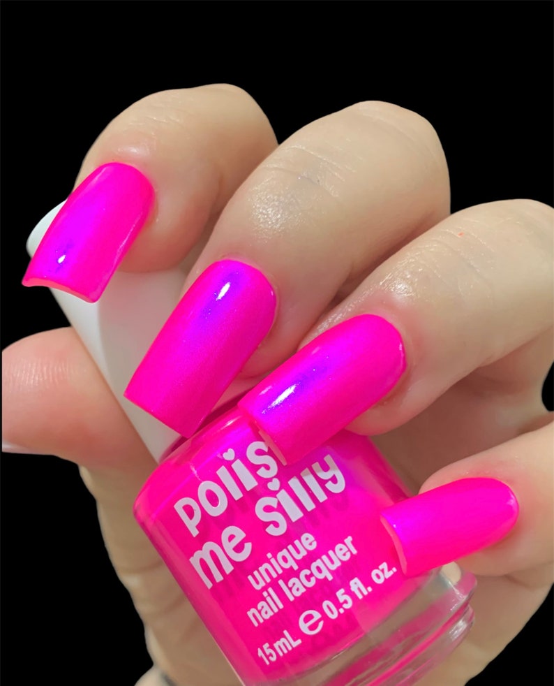 May include: A pink nail polish bottle with the text "pois me silly" and "unique nail lacquer" on the label. The bottle is 15 ml or 0.5 fl oz.