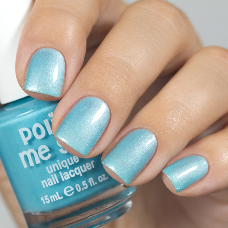 May include: A bottle of light blue nail polish with the brand name "Polished Me" and the text "unique nail lacquer" on the label. The bottle is 15 ml or 0.5 fl. oz.