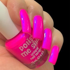 May include: A pink nail polish bottle with the text "Polish Me Silly" and "unique nail lacquer" on the label. The bottle is 15 ml or 0.5 fl oz. The bottle is held in a hand with pink nails painted with the same polish.