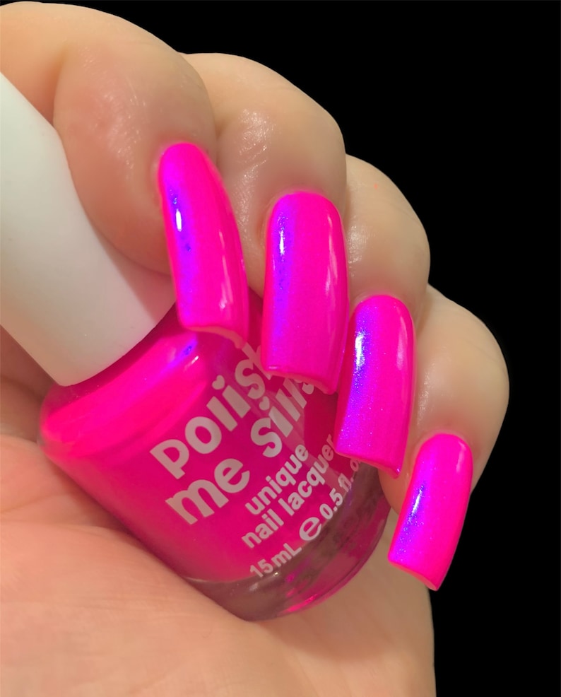 May include: A pink nail polish bottle with the text "Polish Me Silly" and "unique nail lacquer" on the label. The bottle is 15 ml or 0.5 fl oz. The bottle is held in a hand with pink nails painted with the same polish.
