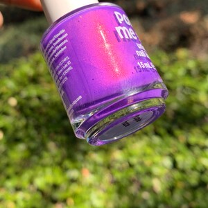 Puede incluir: Un frasco de esmalte de u&ntilde;as morado con un acabado nacarado. El frasco tiene una tapa blanca y la etiqueta dice "Po me". El frasco contiene 15 ml de esmalte de u&ntilde;as.